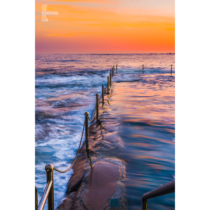 Long exposure photo of Wylies Baths ocean rockpool during sunrise at Coogee