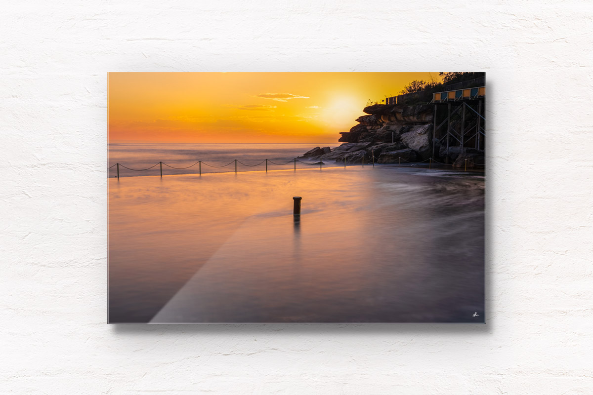 Long exposure of the sun rising over the iconic ocean pool, Wylies Baths in Coogee