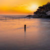 Long exposure of the sun rising over the iconic ocean pool, Wylies Baths in Coogee