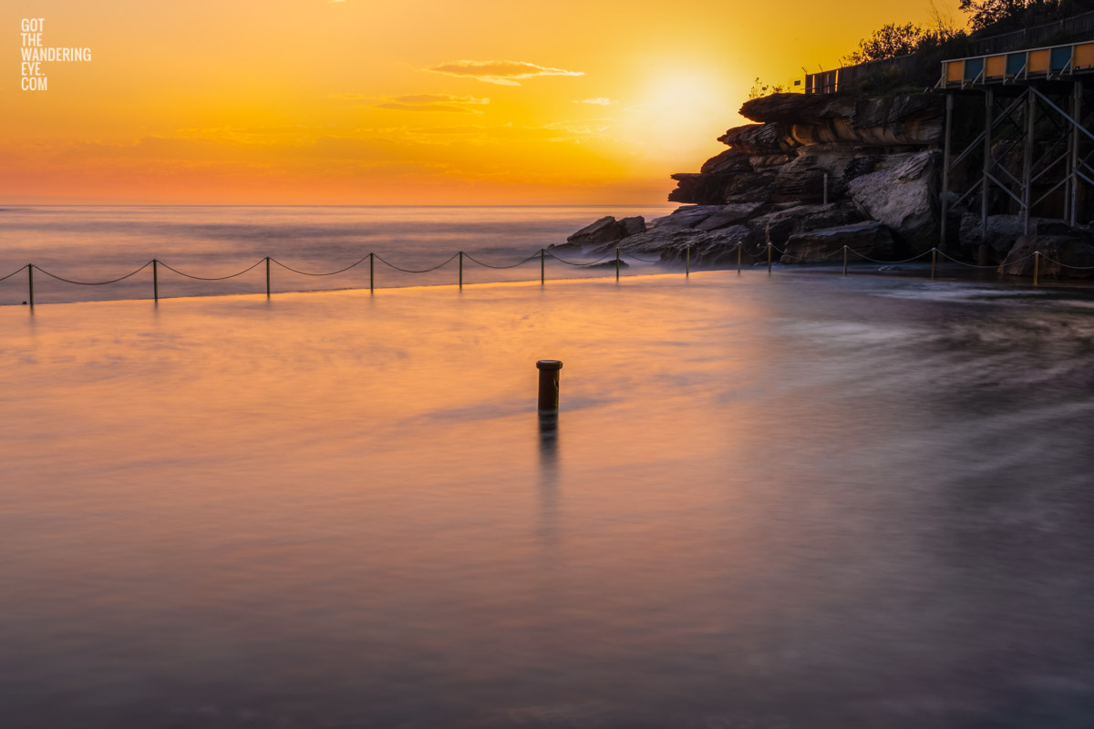Long exposure of the sun rising over the iconic ocean pool, Wylies Baths in Coogee