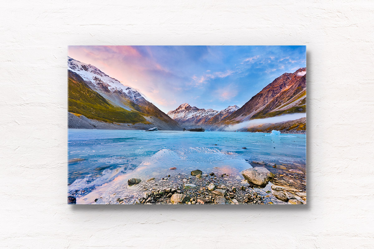 Frozen Hooker Lake with reflection of Aoraki / Mount Cook as the sunsets in New Zealand