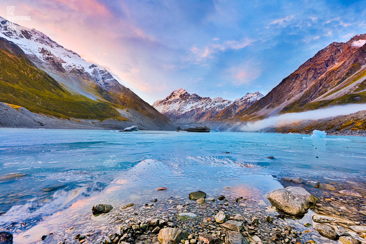 Frozen Hooker Lake with reflection of Aoraki / Mount Cook as the sunsets in New Zealand