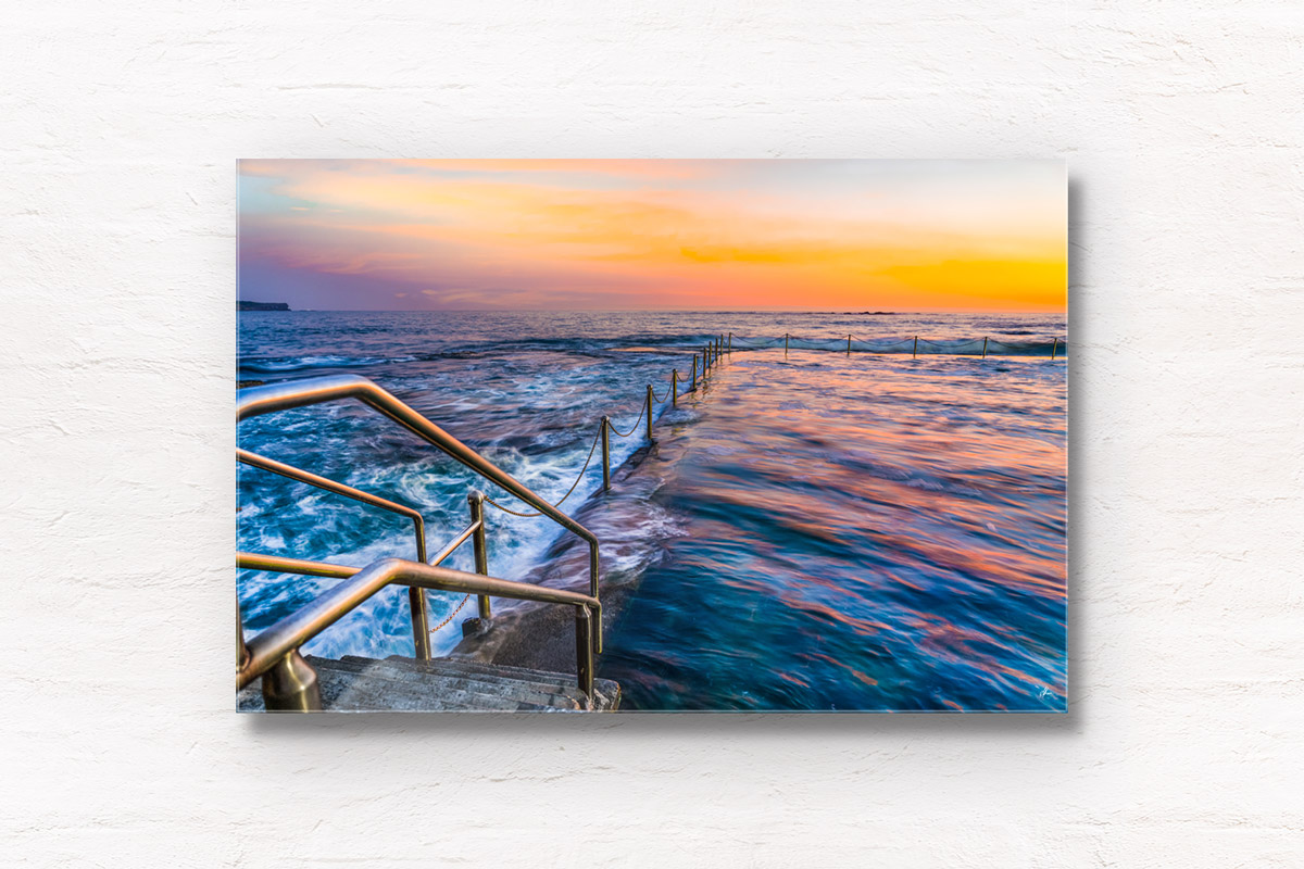Long exposure photo of Wylies Baths ocean rockpool during sunrise at Coogee