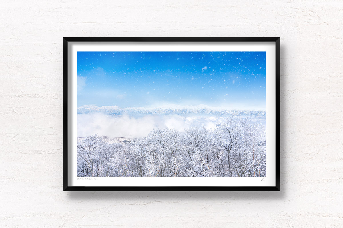 Mountains appearing above a sea of clouds and snowy trees in Nozawa Onsen, Japan
