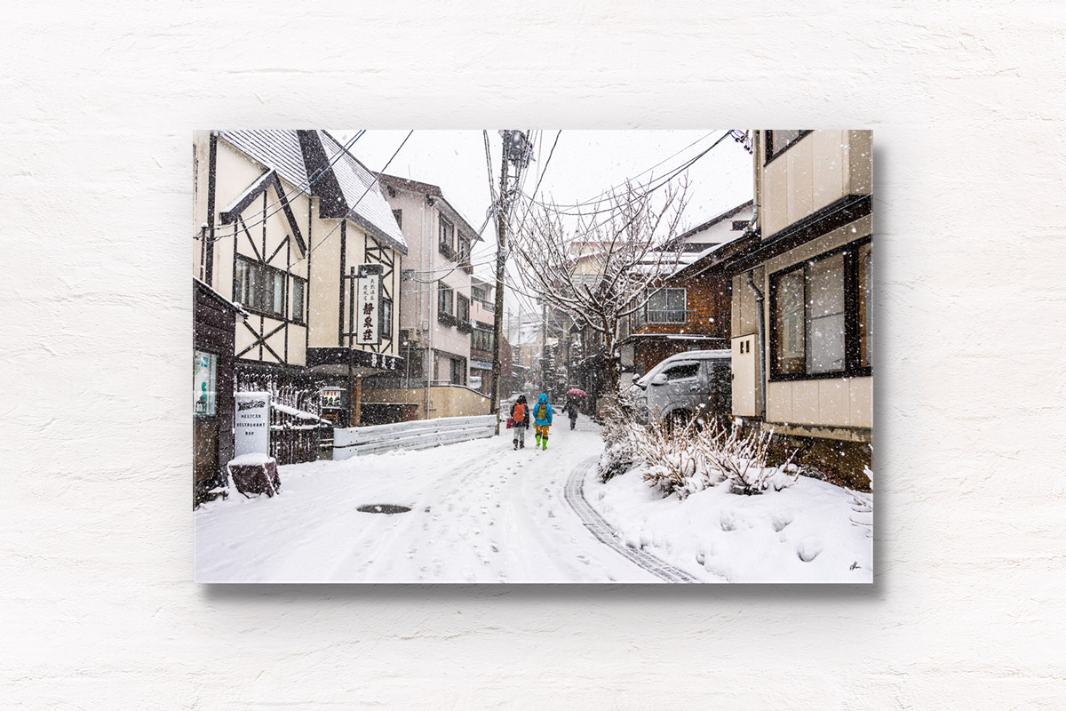 Local villagers walking around Nozawa Onsen village in Japan during snowfall in winter