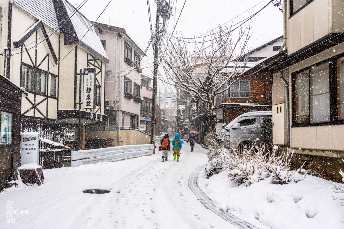 Local villagers walking around Nozawa Onsen village in Japan during snowfall in winter