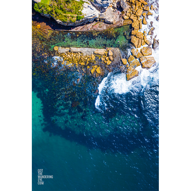 Aerial seascape above swimmers enjoying Giles Bath in Coogee