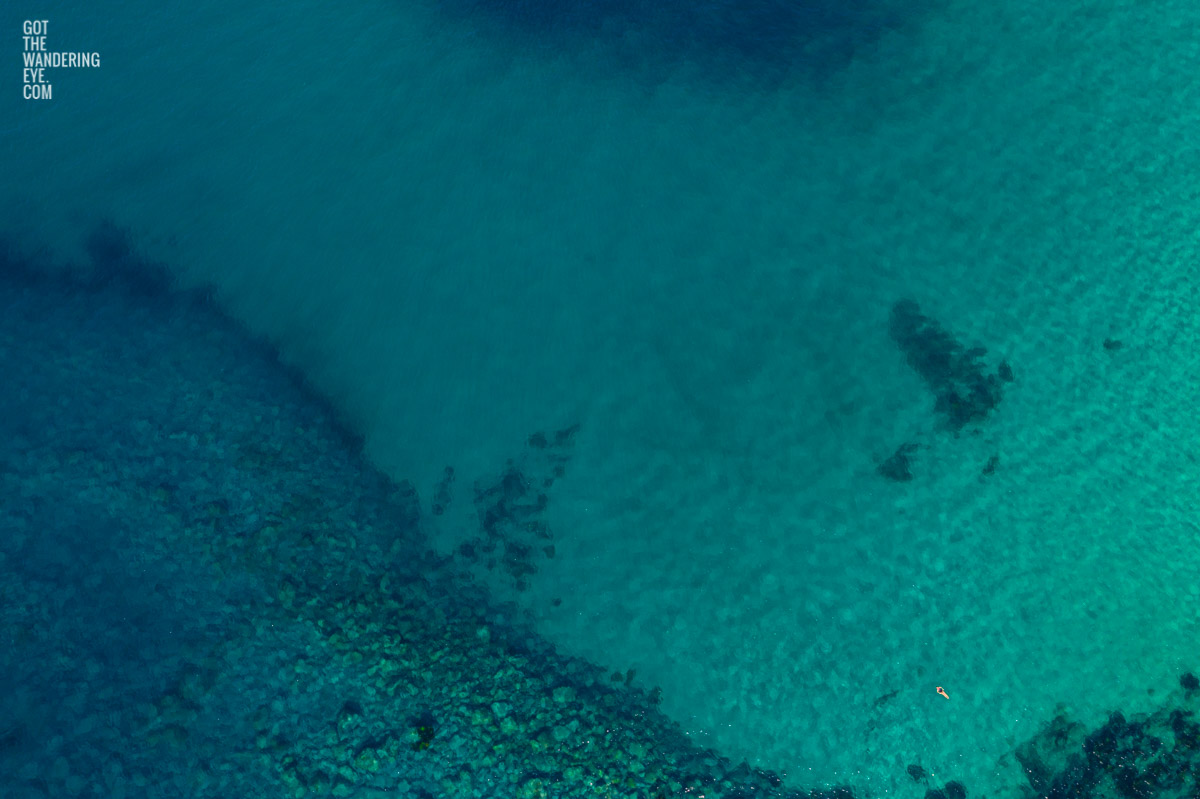 Aerial seascape above a lone swimmer enjoying the secluded sanctuary of North Bondi Beach