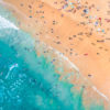 Aerial seascape above a packed Bondi Beach on a gorgeous Summers Day.