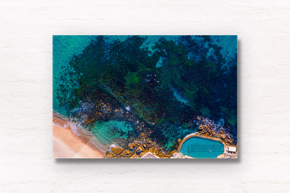 Aerial seascape above the blue waters of Bronte Beach Rockpool.