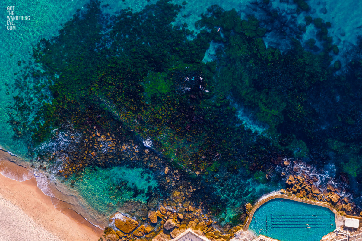 Aerial seascape above the blue waters of Bronte Beach Rockpool.