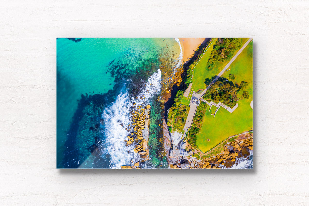 Aerial seascape above the clear turquoise waters of Giles Baths, Coogee