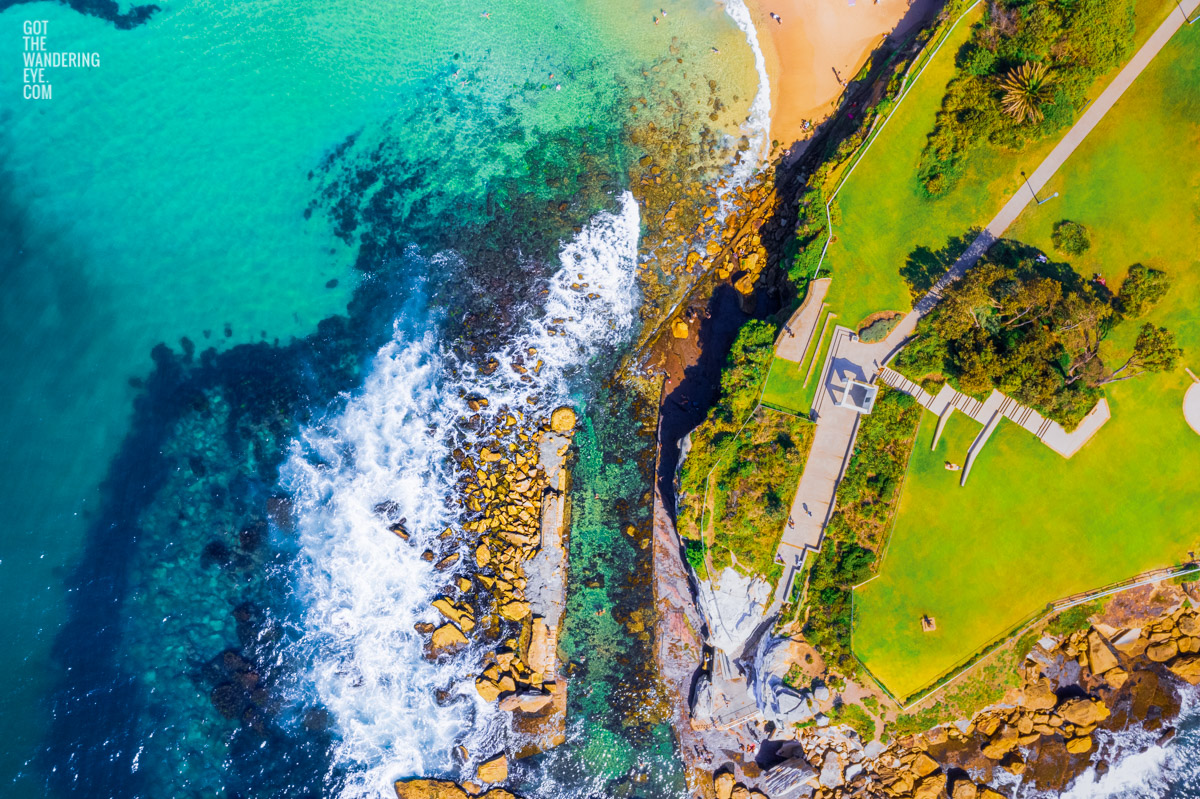 Aerial seascape above the clear turquoise waters of Giles Baths, Coogee