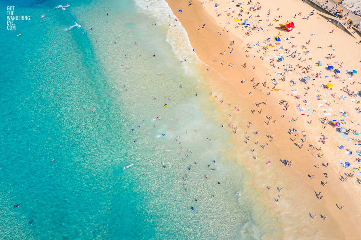 Aerial seascape above a packed Bondi Beach on a gorgeous Summers Day.