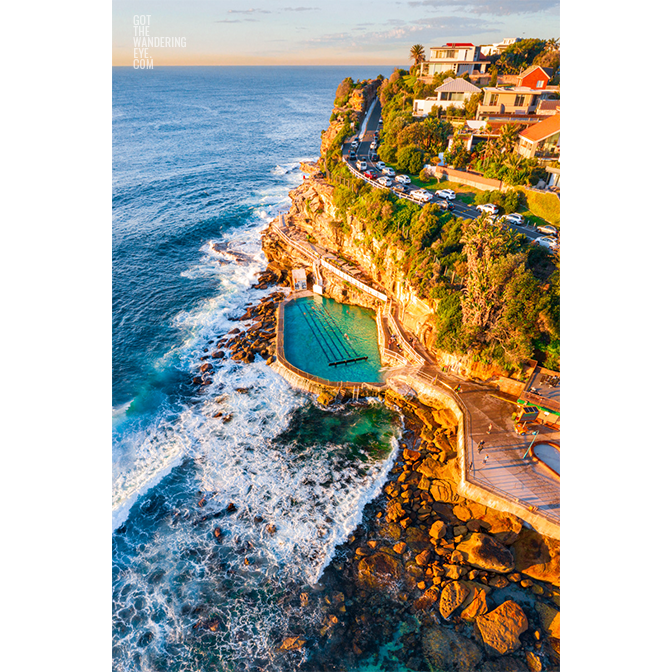 Aerial seascape of Bronte Rockpool bathed in a warm glow from the sunrise during Winter.