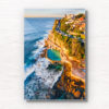 Aerial seascape of Bronte Rockpool bathed in a warm glow from the sunrise during Winter.