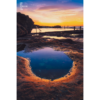 Fiery purple sky sunrise in a puddle of water at Mahon Pool, Maroubra