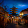 Woman walking in kimonos under the beautiful moonlight and lit lanterns in the Higashiyama District at Yasaka Pagoda, Kyoto, Japan
