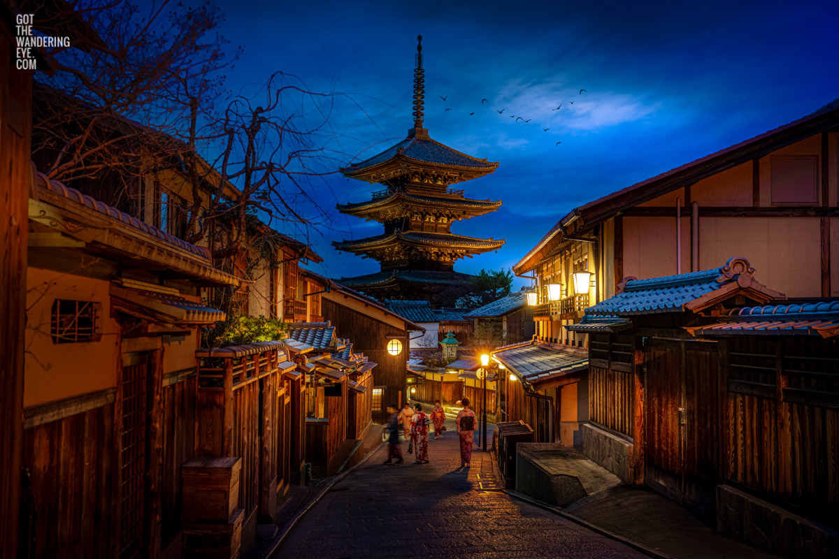 Woman walking in kimonos under the beautiful moonlight and lit lanterns in the Higashiyama District at Yasaka Pagoda, Kyoto, Japan