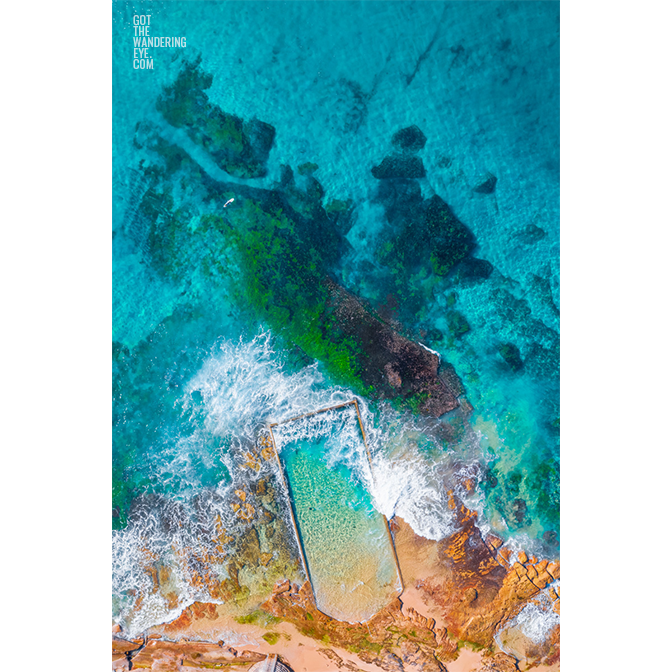 Aerial oceanscape above crystal clear waters of North Cronulla Beach Rockpool