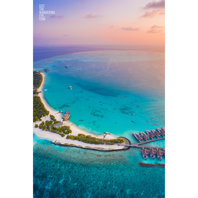 Maldives aerial view landscape above a beautiful sunset above the tiny paradise island of Fairmont Maldives.