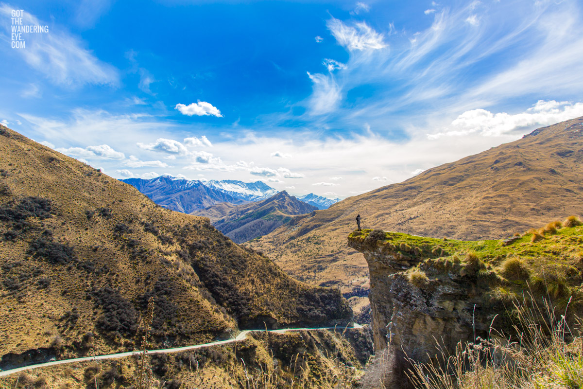 Woman standing on canyons edge admiring the splendid mountainous view of Skippers Canyon in New Zealand