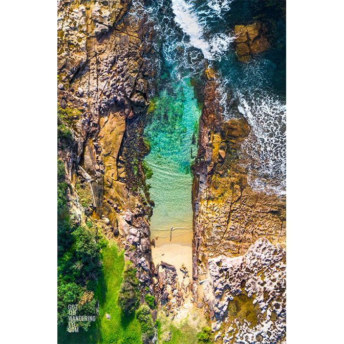 Aerial oceanscape above a woman standing on Cronulla Beach