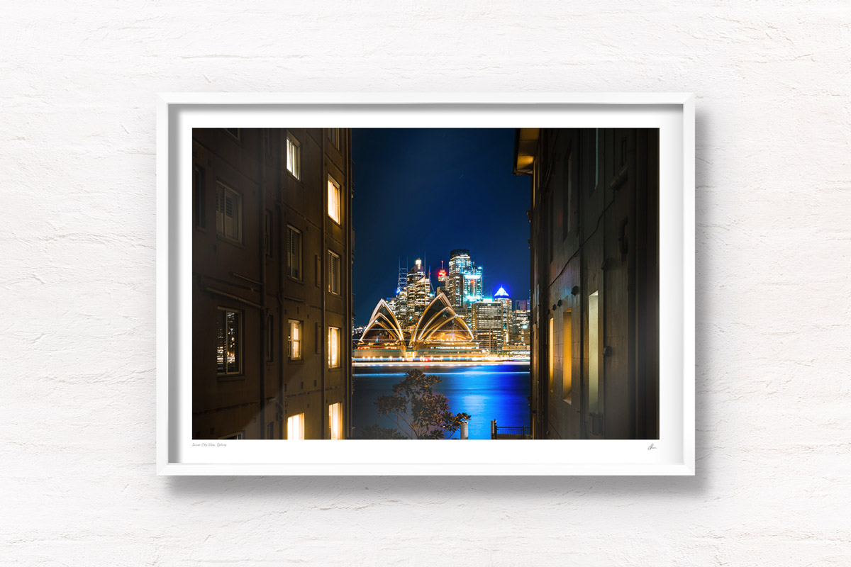 Long exposure photography of ferries going past the sparkling Sydney Opera House on a clear winters night in Sydney overlooking Beulah St wharf.