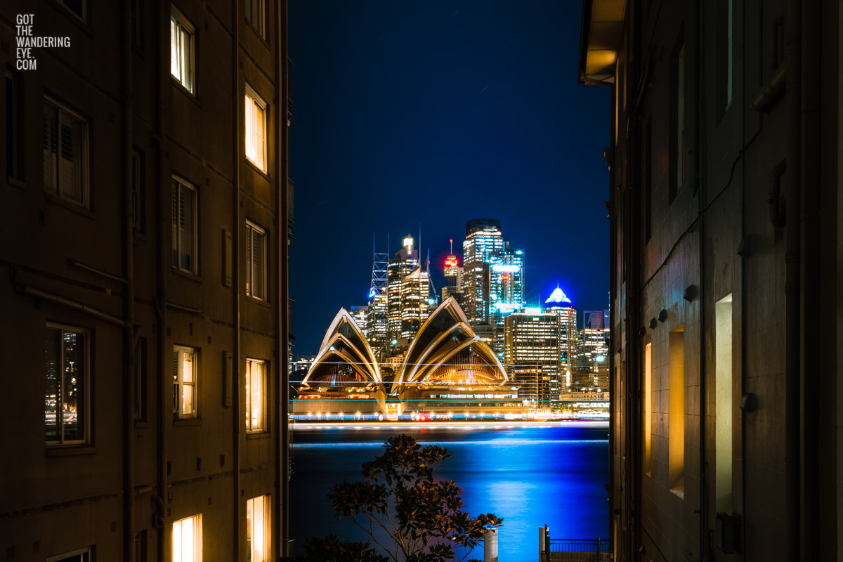 Long exposure photography of ferries going past the sparkling Sydney Opera House on a clear winters night in Sydney overlooking Beulah St wharf.