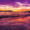 Long exposure of a gorgeous pink sky sunset, creating a silhouette over the Sydney skyline, taken from Milk Beach Vaucluse.