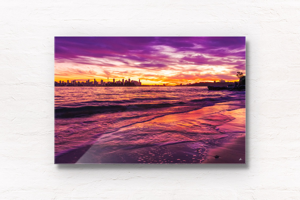 Long exposure of a gorgeous pink sky sunset, creating a silhouette over the Sydney skyline, taken from Milk Beach Vaucluse.