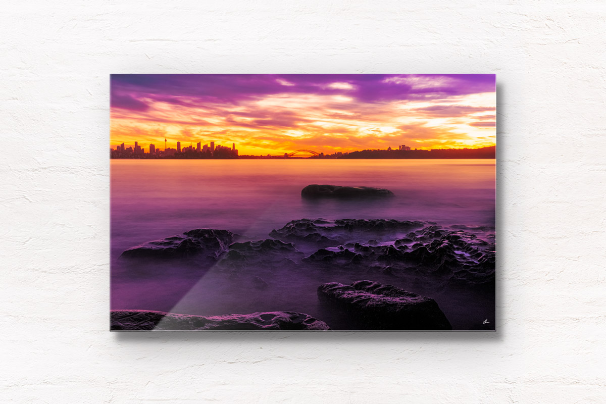 Long exposure of a gorgeous pink sky sunset, creating a silhouette over the Sydney skyline, taken from Milk Beach Vaucluse.