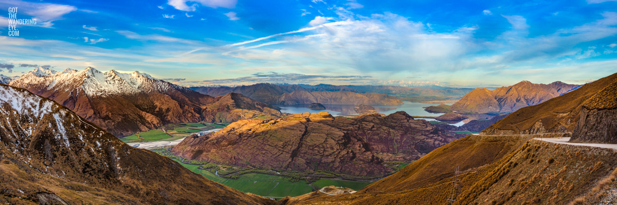 The most spectacular panoramic view down from the top of Treble Cone Road over Rocky Mountains to Lake Wanaka, New Zealand