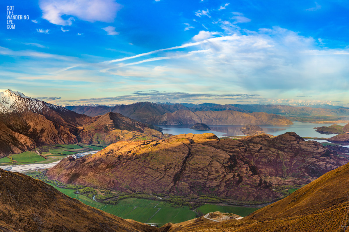 The most spectacular view down from the top of Treble Cone Road over Rocky Mountains to Lake Wanaka, New Zealand