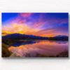 Stunning silky pink sunset sky with reflection of mountains of Wanaka New Zealand