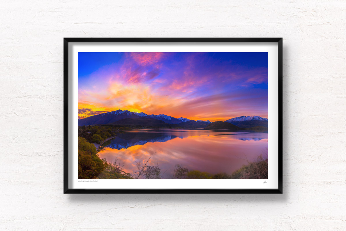 Stunning silky pink sunset sky with reflection of mountains of Wanaka New Zealand