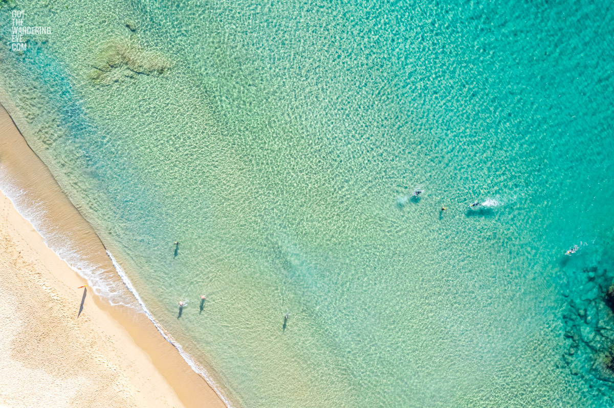 Aerial oceanscape above swimmers enjoying crystal clear ocean beach waters of South Cronulla Beach
