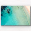 Aerial oceanscape above secluded crystal clear ocean beach waters of South Cronulla Beach