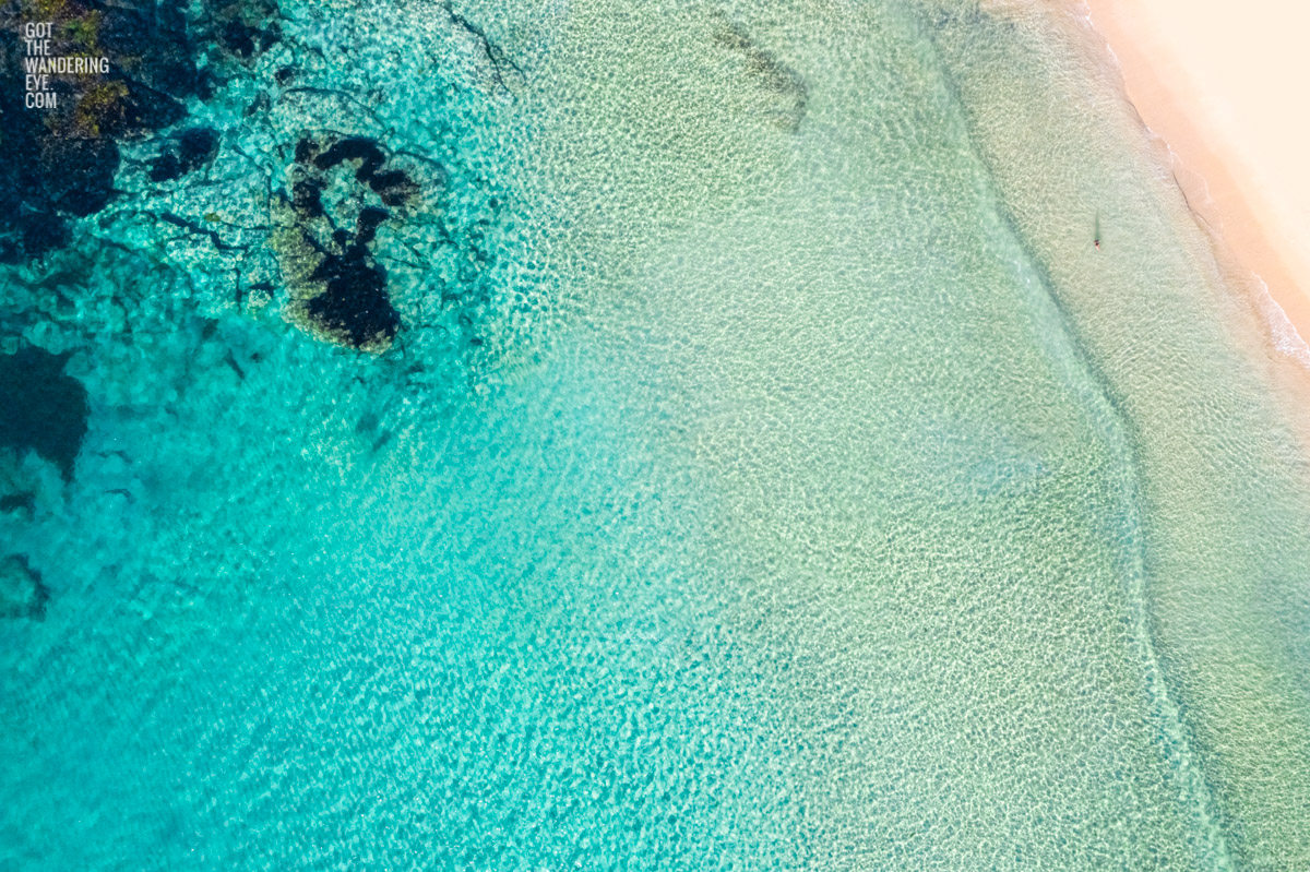 Aerial oceanscape above secluded crystal clear ocean beach waters of South Cronulla Beach