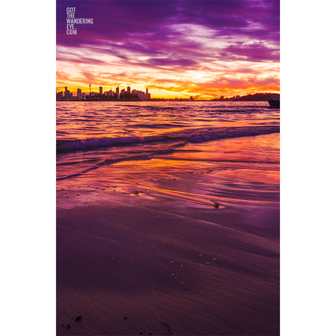 Long exposure of a gorgeous pink sky sunset, creating a silhouette over the Sydney skyline, taken from Milk Beach Vaucluse.