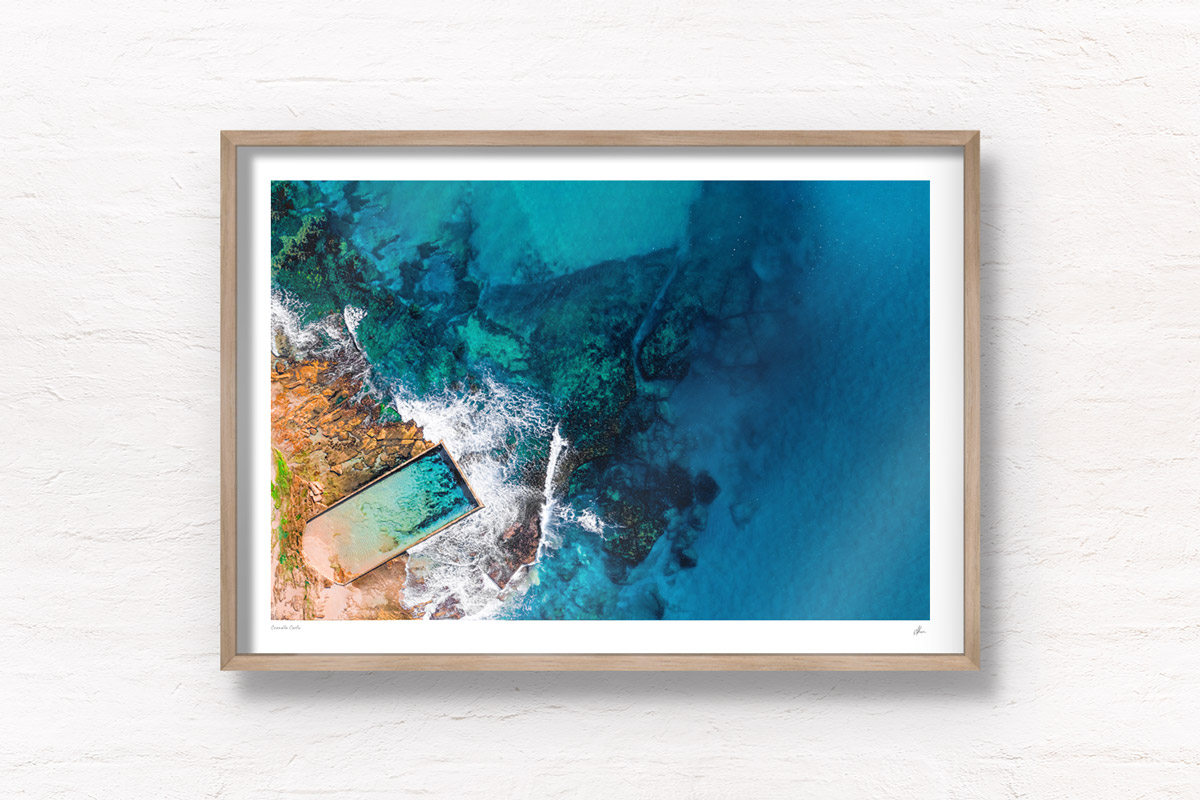 Fine art framed print of an aerial oceanscape above the gorgeous blue waters of North Cronulla ocean, rockpool. Surrounded by beautful coloured waters like the greek island of Corfu.