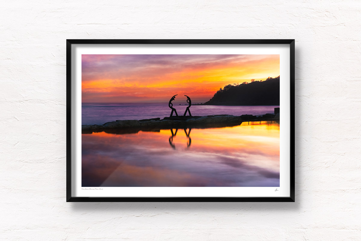 Fine art framed print of purple sky sunrise at Fairy Bower rock, ocean pool at manly beach. Silhouette of Oceanides sculpture – also known as Sea Nymphs.