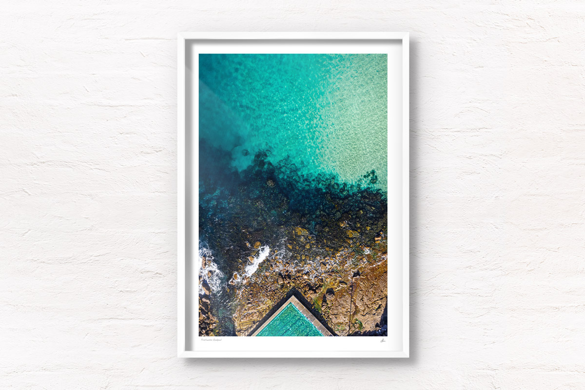 Fine art framed print of a aerial oceanscape above crystal clear waters of Freshwater Beach. Ocean, rockpool summertime.