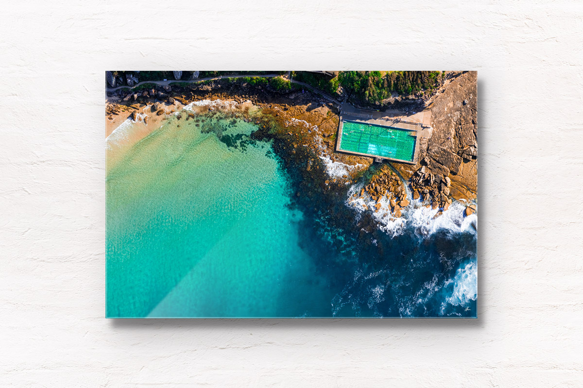 Aerial oceanscape above turquoise crystal clear waters of Freshwater Rockpool. Summer, swimming, oceanpool