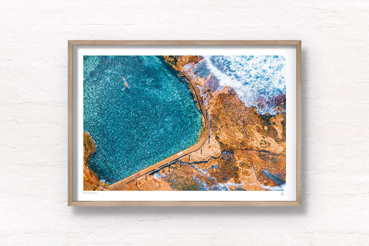 Fine art framed print of a woman diving into crystal clear ocean rockpool waters of Mahon Pool, Maroubra.
