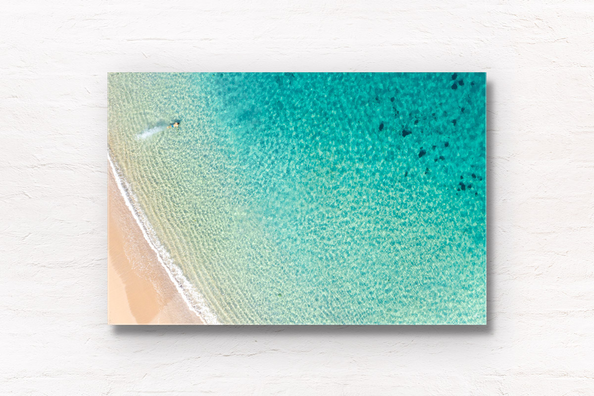 But fine art framed print of a aerial oceanscape above turquoise clear waters of a man diving into Shelly Beach, Manly.