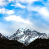 Woman gazing at the peak of Aoraki Mount Cook New Zealand by Allan Chan