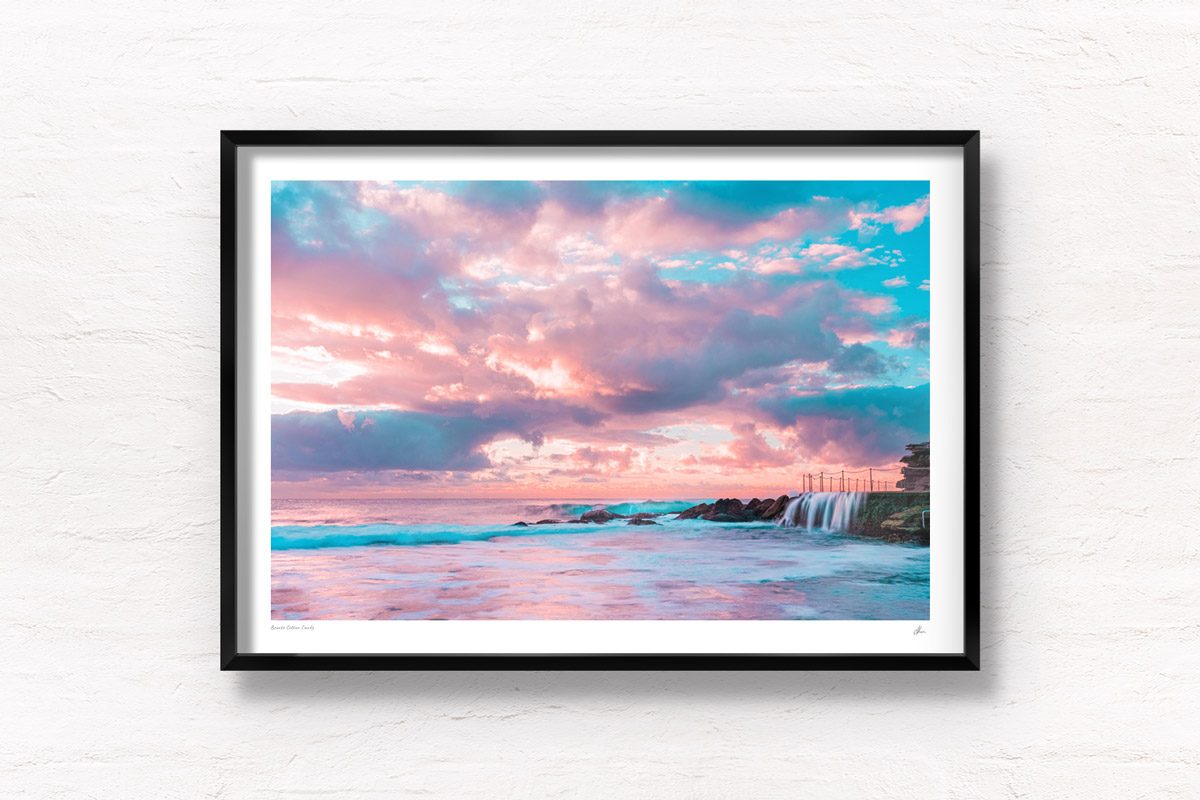 Puffy cotton candy coloured clouds during sunrise at Bronte baths Rockpool.