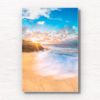 Long exposure of crashing waves flowing onto Tamarama Beach as a sparkling sunrises over Tamarama Surf Life Saving Club.