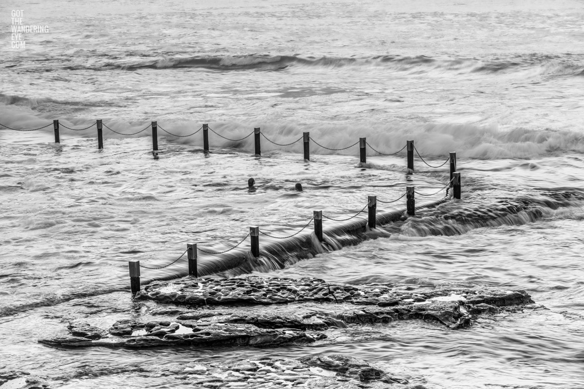 2 woman enjoying a swim at Maroubra. Waves crashing over mahon pool ocean rockpool.